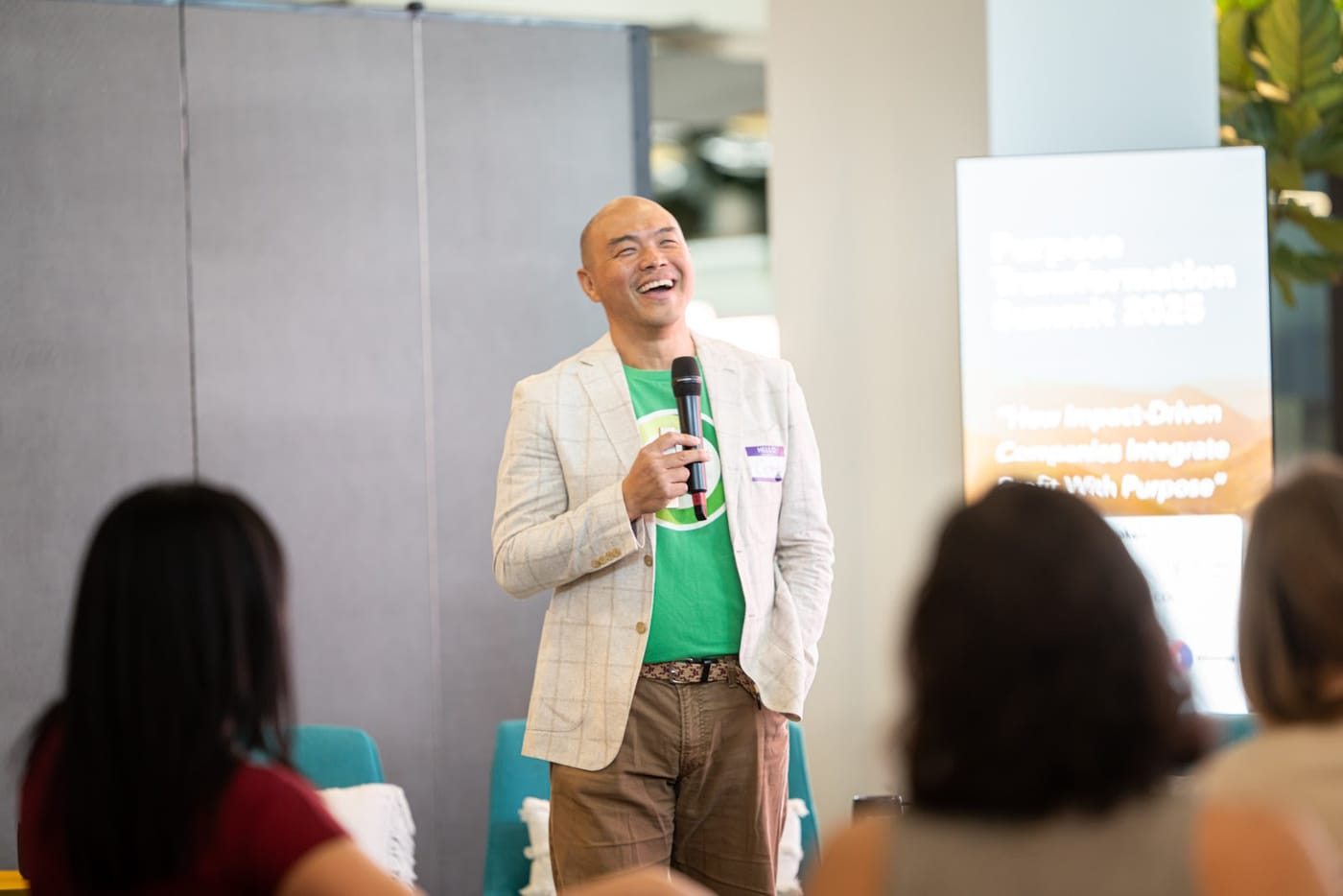 DOMI co-founder Corey Lien speaking on stage at the Purpose Transformation Summit in Canada
