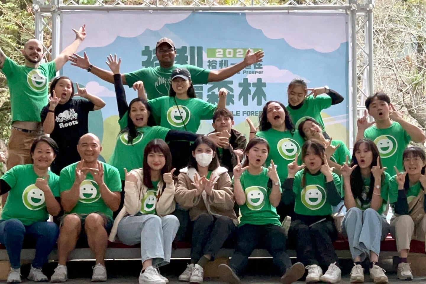 Taiwanese and international colleagues in DOMI smiley tees cheering at the Zuellig Pharma planting party